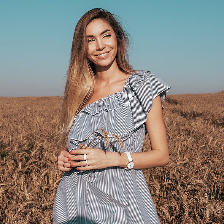 loose skin surgery patient model in a field wearing a blue dress