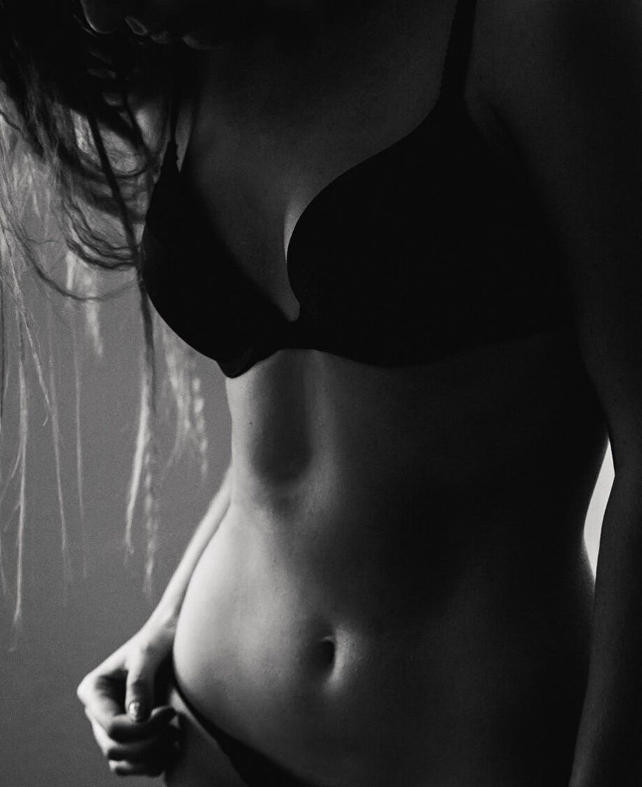 Philadelphia breast surgery patient model in black underwear with a toned abdomen