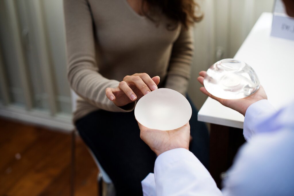 Philadelphia plastic surgeon Dr. Ran Stark showing a breast augmentation patient the two different types of breast implants