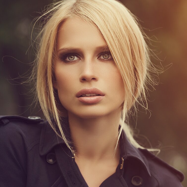 blonde rhinoplasty patient model in a black button up shirt