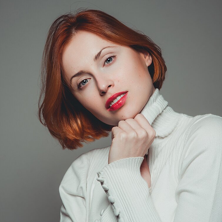 red haired Philadelphia Sciton laser model in a white turtleneck